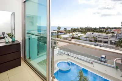 a room with a large window with a view of a city at LAILA - Coralli Beachfront Apartment in Protaras