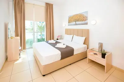 a bedroom with a large bed and a window at ALICIA - Coralli Beachfront Apartment in Paralimni