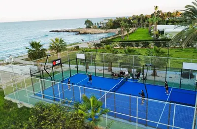 an overhead view of a tennis court next to the ocean at BLISS - Coralli Beachfront Apartment in Protaras