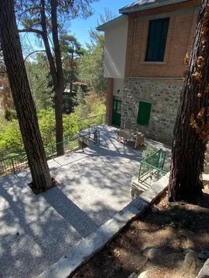 a building with two trees in front of it at ThePlatres.Nest in Platres
