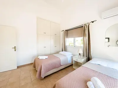 a bedroom with two beds and a window at FAME villa with Private Pool and Gazebo in Ayia Napa