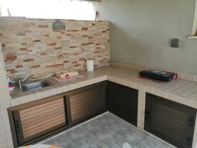 a kitchen with a sink and a counter top at Extremely comfy apt with spacious private terrace 10min walk to the beach & in Town in Larnaka