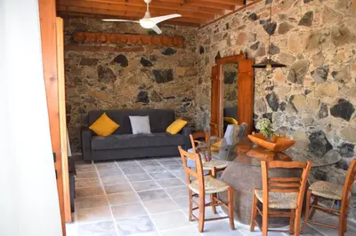 a living room with a table and chairs and a couch at Konatzin tou Massou by Raise in Moutoullas
