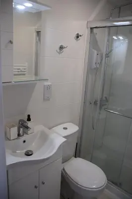a white bathroom with a toilet and a shower at Konatzin tou Massou by Raise in Moutoullas