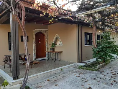 a porch of a house with a table and a door at IRENE cottage in Kakopetria