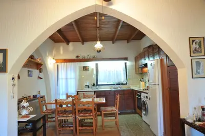 a kitchen and dining room with an arched ceiling at IRENE cottage in Kakopetria