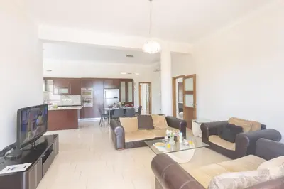 a living room with a couch and a tv at Sparta Luxury Villa in Protaras