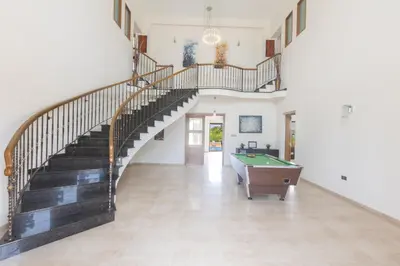 a hallway with a staircase and a pool table at Sparta Luxury Villa in Protaras
