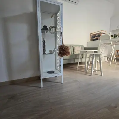 a living room with a mirror and a table at Maison Zenon Larnaca City Center apartments in Larnaka