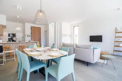 a dining room and kitchen with a table and chairs at Waves 3-Bedroom Villa in Protaras in Paralimni