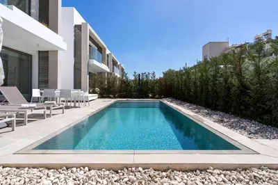 a swimming pool in the middle of a house at Waves 3-Bedroom Villa in Protaras in Paralimni