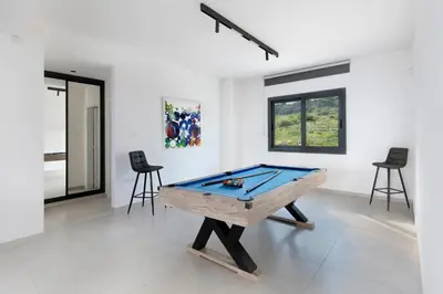 a pool table in a room with chairs at The Oasis in Protaras