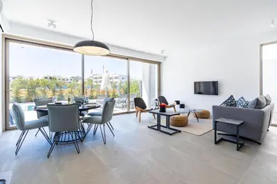 a living room with a table and chairs and a couch at Cyan 3-Bedroom Villa in Protaras in Paralimni