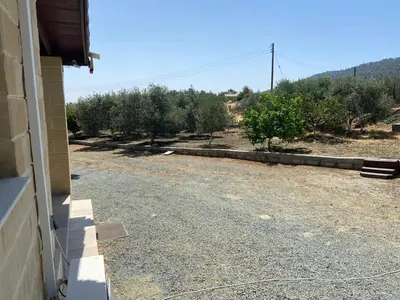 a side view of a driveway with trees and bushes at Stavros Country House in Siá