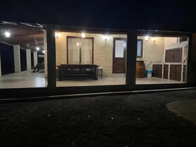 a view of a house with a patio at night at Stavros Country House in Siá