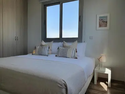 a large white bed in a room with a window at Phaedrus Living: City Center Cozy Flat Demetra 102 in Larnaka