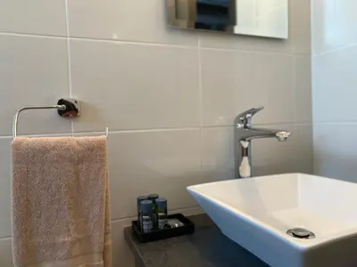 a bathroom with a sink and a towel on a counter at Phaedrus Living: City Center Cozy Flat Demetra 102 in Larnaka