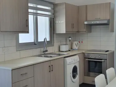 a kitchen with a sink and a washing machine at Phaedrus Living: City Center Cozy Flat Demetra 102 in Larnaka