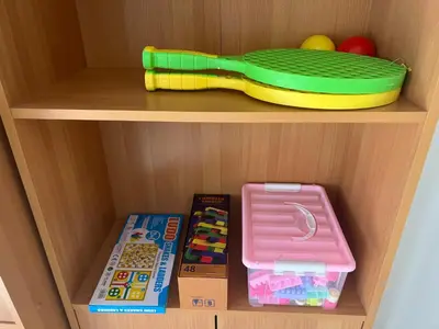 a toy shelf with a toy tray and other toys at TaniAndres apartments in Paralimni