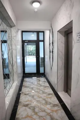 a hallway with a door and a tile floor at Όμορφο καινούργιο διαμέρισμα σε μικρή πολυκατοικία in Voroklini