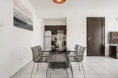 a kitchen and dining room with a table and chairs at Lovely 2 Bedroom Family Apartment w/ Pool in Protaras
