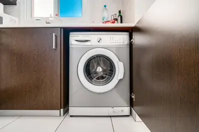 a washing machine in a kitchen next to a counter at Lovely 2 Bedroom Family Apartment w/ Pool in Protaras