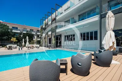 a swimming pool in front of a building at Lovely 2 Bedroom Family Apartment w/ Pool in Protaras