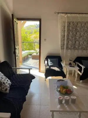 a living room with a couch and a table at Veranda in Agros