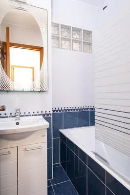a bathroom with a tub and a sink and a mirror at The Saline Views Makenzy in Larnaka