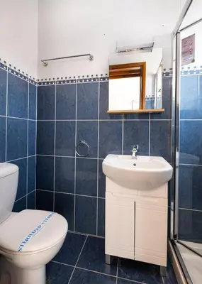 a bathroom with a toilet and a sink at The Saline Views Makenzy in Larnaka