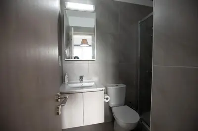 a bathroom with a toilet and a sink and a mirror at Carme at the Beach - Mythical Sands in Paralimni
