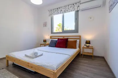a bedroom with a bed and a window at Kmeidos 1-Bedroom Apartment in Larnaca in Larnaka
