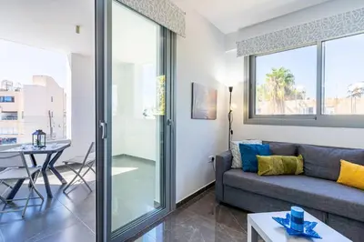 a living room with a couch and a table at Kmeidos 1-Bedroom Apartment in Larnaca in Larnaka