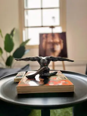 a statue of a bird sitting on a book on a table at The Old Town Heritage House in Nicosia