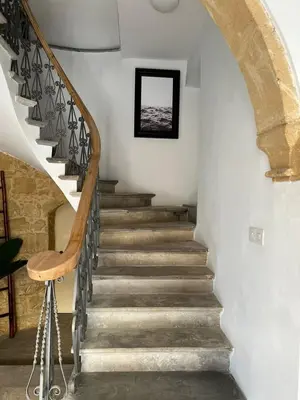 a staircase in a house with a stone wall at The Old Town Heritage House in Nicosia