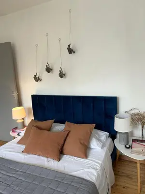 a bed with a blue headboard in a bedroom at APHRODITE 2 Bedroom Apartment Down Town Nicosia in Nicosia