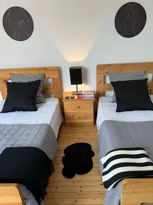 a bedroom with two beds and a night stand with a lamp at APHRODITE 2 Bedroom Apartment Down Town Nicosia in Nicosia