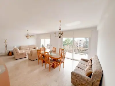 a living room with a couch and a table and chairs at Samson Sea Breeze, 3bed sleeps 6, free WiFi in Limassol