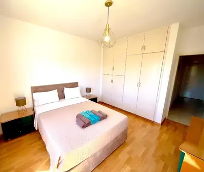 a bedroom with a white bed and a white cabinet at Samson Sea Breeze, 3bed sleeps 6, free WiFi in Limassol