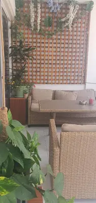 a living room with a couch and some plants at STEFARIS 