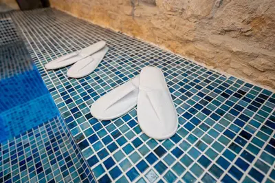 two pairs of shoes sitting on top of a tiled floor at Palazzino Luxury Suites in Lofou