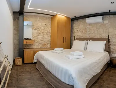 a bedroom with a large bed with towels on it at Palazzino Luxury Suites in Lofou
