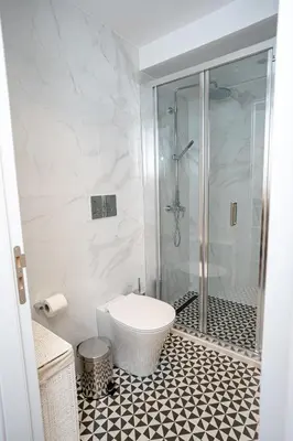 a bathroom with a shower and a toilet in it at Palazzino Luxury Suites in Lofou