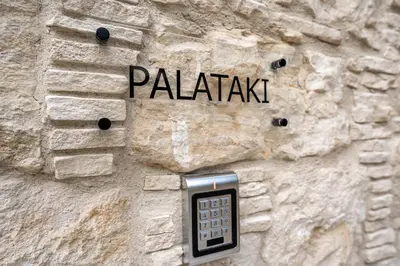 a cell phone on the side of a stone wall at Palazzino Luxury Suites in Lofou