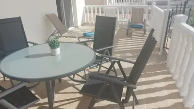 a table and chairs sitting on a balcony at Nissi Golden Sands Sunny Apartment A1D4 in Ayia Napa