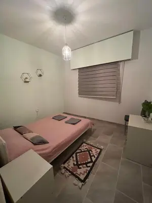 a small room with a bed and a window at Joanna Court rooms in Larnaka