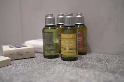 four bottles of green liquid sitting on a counter at 360 Nicosia - 1 bedroom Luxurious Residence in Nicosia