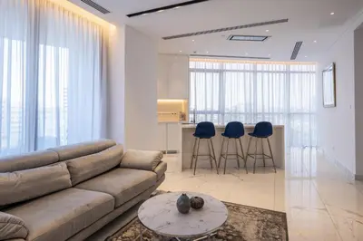 a living room with a couch and two blue stools at 360 Nicosia - 1 bedroom Luxurious Residence in Nicosia