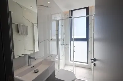 a bathroom with a sink and a toilet and a mirror at Almaria Villas in Protaras