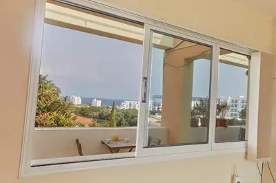 a window with a view of the city at Spectacular Sea View, private jacuzzi & table pool in Protaras